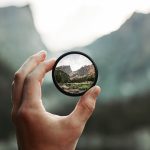 A stunning mountain landscape magnified through a handheld lens highlighting exploration and adventure.