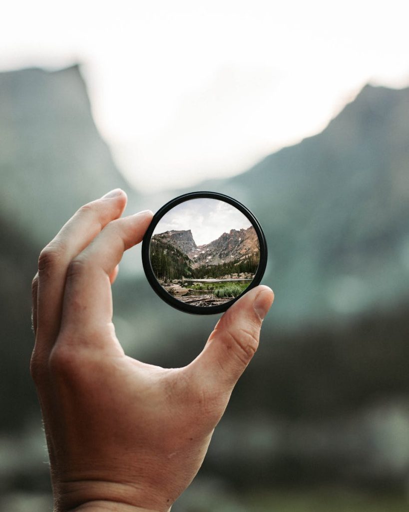 A stunning mountain landscape magnified through a handheld lens highlighting exploration and adventure.