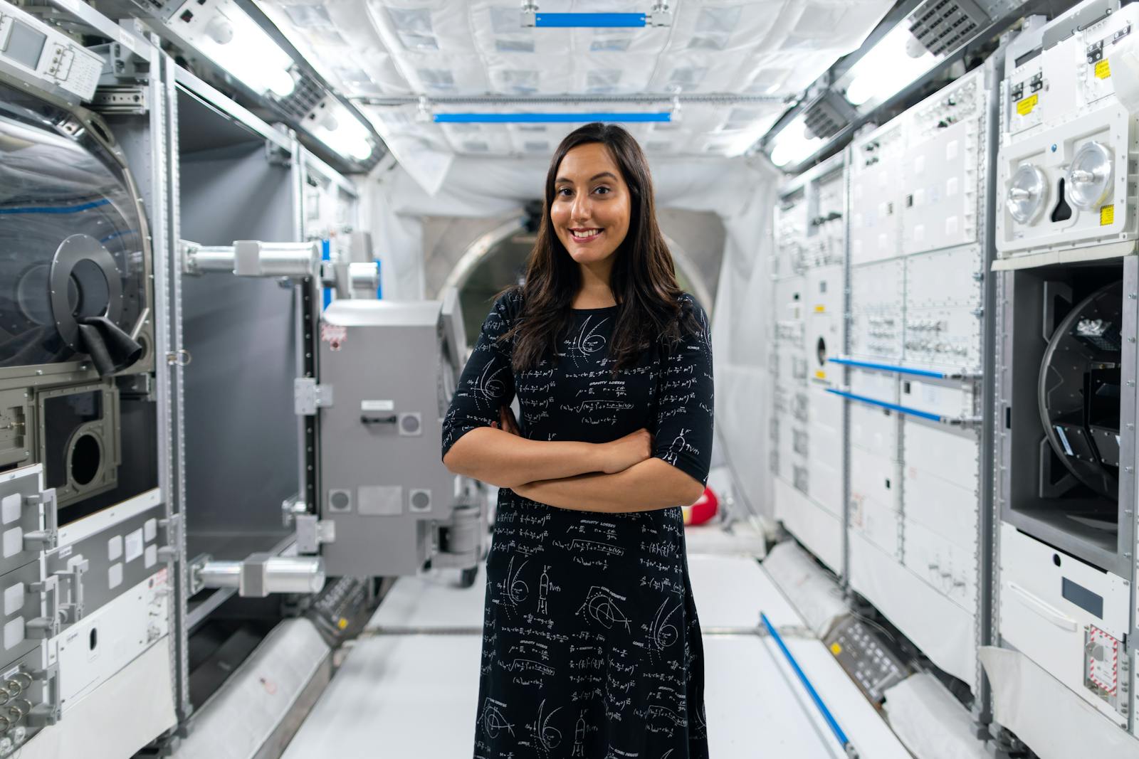 A smiling female scientist in a futuristic space station, symbolizing innovation and exploration.