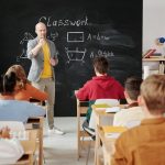 Teacher explaining geometry as students engage in a modern classroom setting.