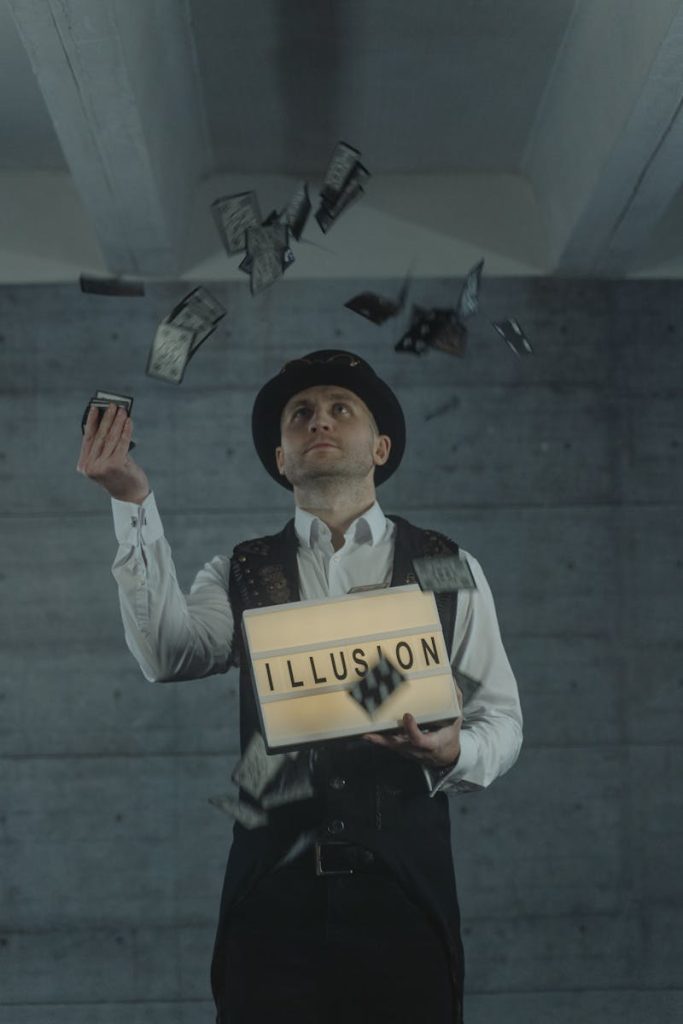 A magician performing a card trick with an 'ILLUSION' sign indoors, creating a mysterious atmosphere.