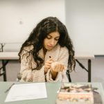 Female student discreetly cheating during an exam at school, showcasing the stress and pressures of academics.