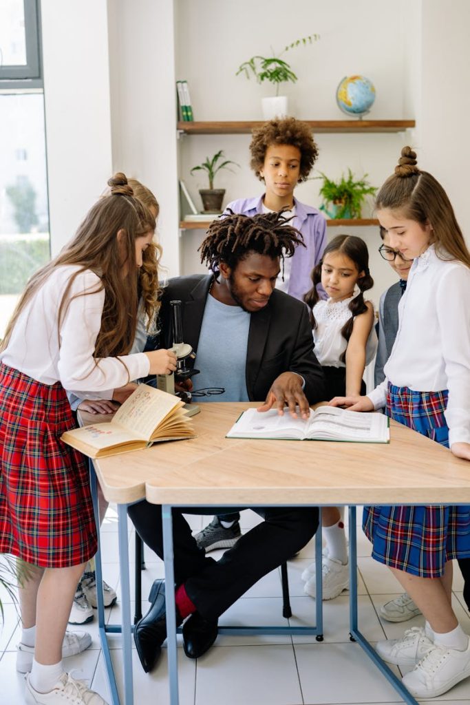 A teacher engages with students in a diverse classroom, fostering active learning.