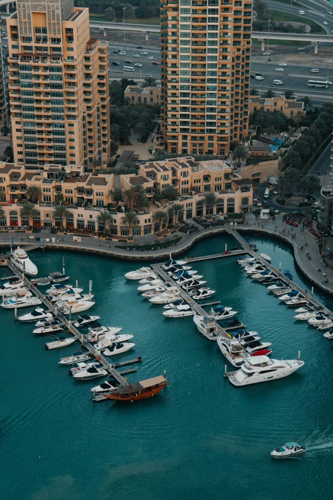 Stunning aerial capture of a luxury marina with yachts and skyscrapers in the background.